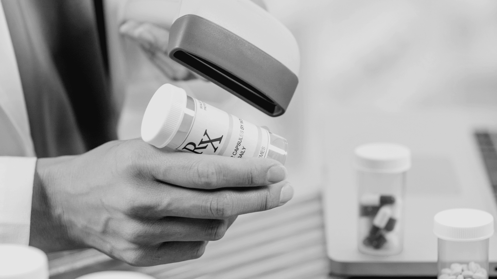 A pharmacist scans a prescription bottle, representing the tracking of data across the supply chain in accordance with the DSCSA and CSA protocols.