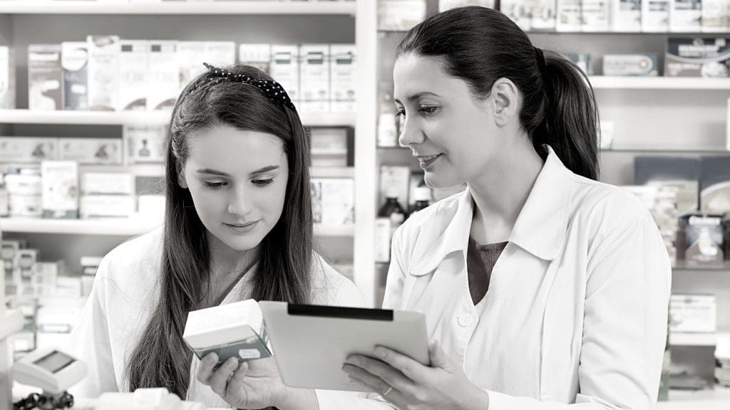 two pharmacists check records
