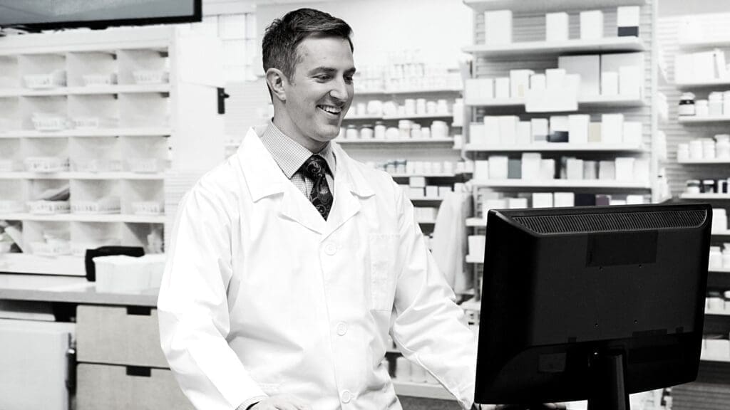 Pharmacist using a computer pioneerrx c2keep